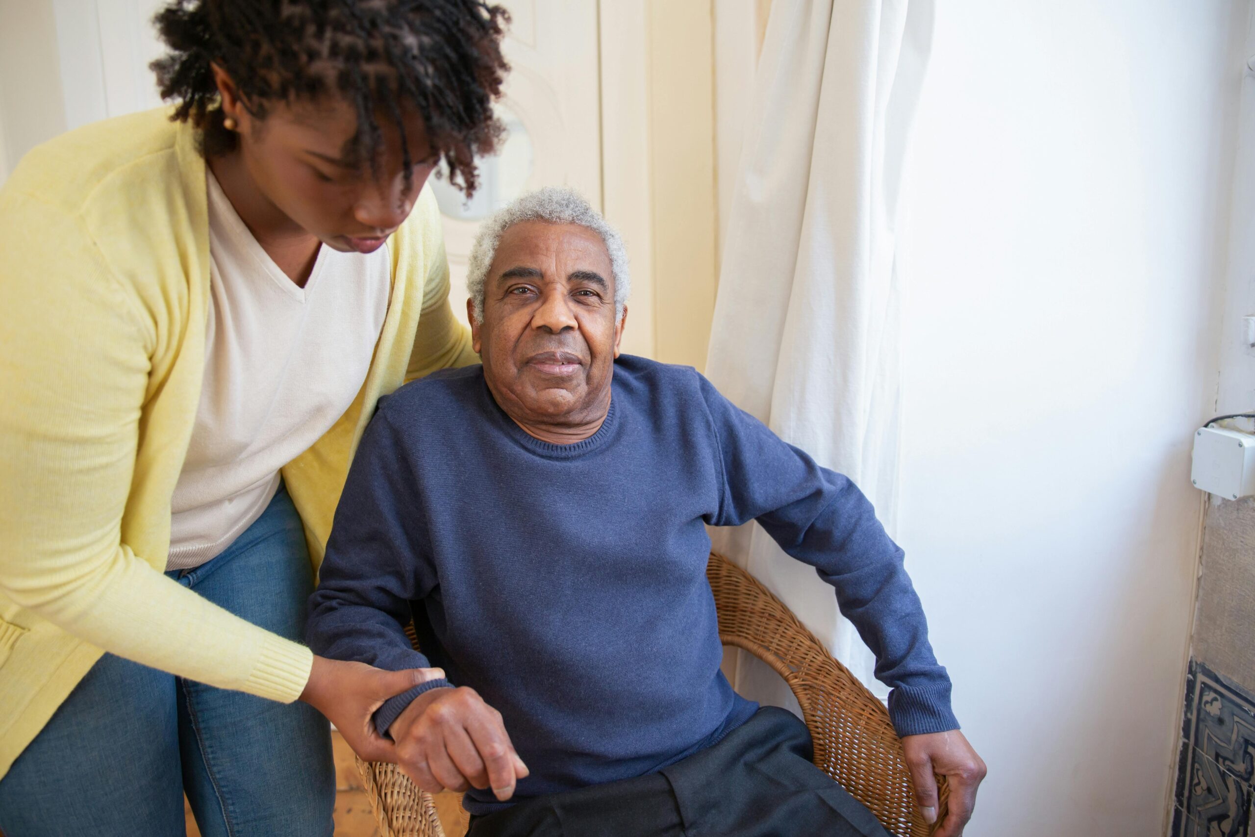 A support worker helping a participant at home