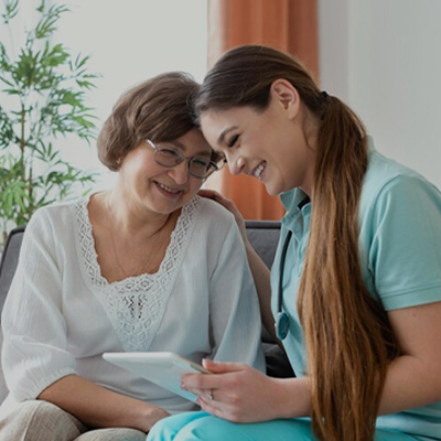 A support worker sharing a friendly moment with an elderly participant